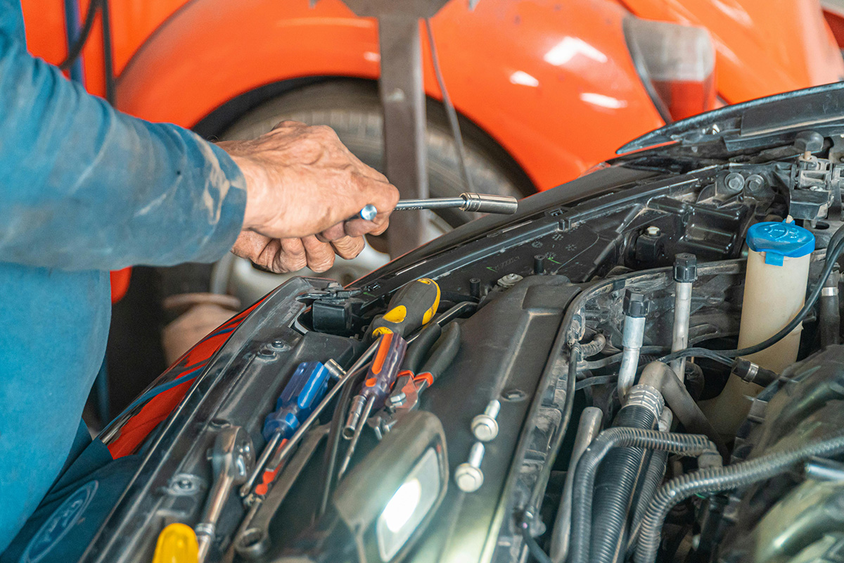 Man working under the hood of a car