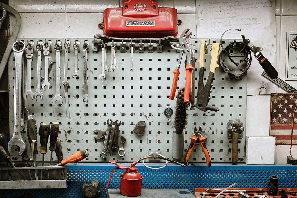 power tools hanging on a wall in an auto shop