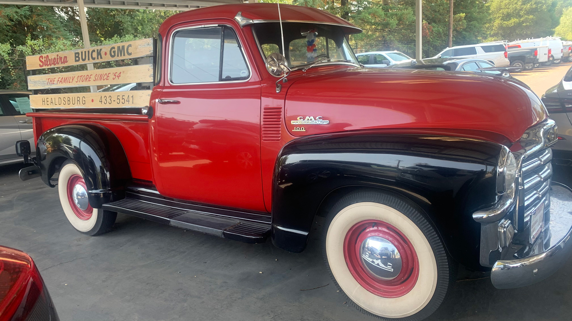 Red truck with black trim and white wheels