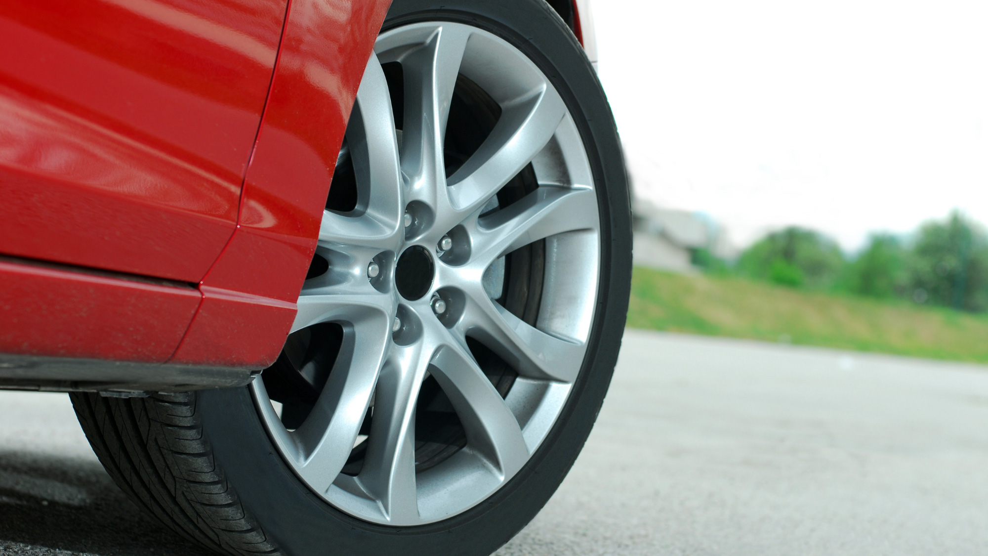 A close up image of a car’s wheel and tire as it turns to the right